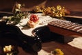 Dried flowers and electric guitar on vintage music notes closeup. Selective focus Royalty Free Stock Photo