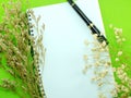 Dried flowers and empty notebook page Royalty Free Stock Photo