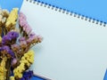 Dried flowers and empty notebook page Royalty Free Stock Photo