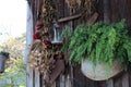 Dried Flowers and Farm Tools hanging on side of cabin.