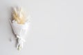 Dried flowers in minimalist bouquet on light background. Flowers composition. Flat lay, top view, copy space. Love