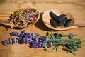 Dried flowers on olive wood spoons, on wooden background