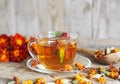 Dried flowers of red flowers black-haired or golden Mary, Turkish carnation with a cup of medicinal tea on a wooden background. Royalty Free Stock Photo