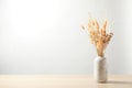 Dried flowers in vase on table against light background. Space for text Royalty Free Stock Photo