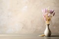 Dried flowers in vase on table against light grey background. Space for text Royalty Free Stock Photo