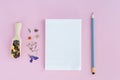 Dried flowers in wooden spoon, notebook and pencil on pink background. Flat lay, top view. Royalty Free Stock Photo