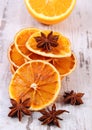 Dried and fresh orange with star anise on old wooden background