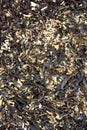 Dried fresh small crumbly black leaves of black tea lie on the table. The view from the top. Close up. Royalty Free Stock Photo