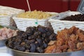 Dried fruit baskets and bowls, dried apricots, dried dates, candied fruit sold at the market Royalty Free Stock Photo