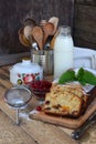 Dried fruit cake with raisins, apricots, cherry. Pastry for Christmas. Sliced freshly baked fruitcake and milk. Breakfast or after Royalty Free Stock Photo