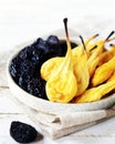 Dried fruit: pears and prunes in a white plate