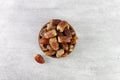 Dried fruit sagay dates in a wooden bowl on a gray background. Top view.