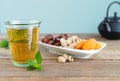 Dried fruit tray with dates, pistachios and dried apricots with tea glass on wooden bottom. Copy space Royalty Free Stock Photo