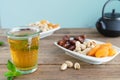 Dried fruit tray with tea glass on wooden background. Copy space Royalty Free Stock Photo