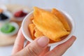 Dried fruit, Yellow mango slice in woman`s hand. Close-up Royalty Free Stock Photo