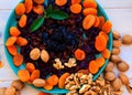 Dried  fruits apricots , cranberries, raisins, prunes and nuts close-up Royalty Free Stock Photo