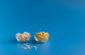 Dried fruits in assortment in glass cups on a blue background. The concept of a healthy lifestyle