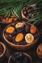 Dried fruits bowl. Healthy food snack: sun dried organic mix of apricots, figs, raisins, dates and other on wooden table, top view Royalty Free Stock Photo