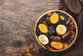 Dried fruits bowl. Healthy food snack: sun dried organic mix of apricots, figs, raisins, dates and other on wooden table, top view Royalty Free Stock Photo