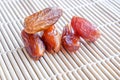 Dried fruits of date palm on bamboo mat background, Phoenix fruit on bamboo mat
