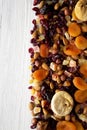 Dried fruits and nut mix on a white wooden background, top view. Overhead, from above, flat lay. Copy space Royalty Free Stock Photo