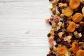 Dried fruits and nut mix on a white wooden background, top view. Overhead, from above, flat lay. Space for text Royalty Free Stock Photo