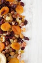 Dried fruits and nut mix on white wooden surface, top view. Copy space Royalty Free Stock Photo