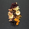 Dried fruits and nuts on a black surface, view from above. Overhead, top view, flat lay Royalty Free Stock Photo