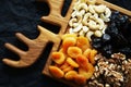 Dried fruits and nuts on a wooden board on a dark background Royalty Free Stock Photo