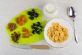 Dried fruits and peanuts on cutting board, milk, corn flakes Royalty Free Stock Photo