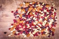 Dried fruits - pecan, cranberry, raisin, almond on wooden