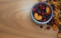 Dried fruits: rose hips, hawthorn, apples, pears, plums in a glass jar on a wooden table - healthy sweet food Royalty Free Stock Photo