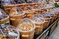 Dried fruits for sale on the market in wooden buckets with lids.