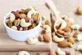 Dried fruits and variety of nuts into a bowl, a wooden spoon on Royalty Free Stock Photo