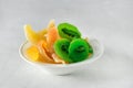 Dried fruits in White Bowl Kiwi Persimmon Melon Gray Background Horizontal Royalty Free Stock Photo