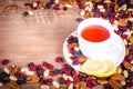 Dried fruits with white cup of tea and saucer