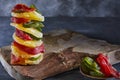 Dried fruits: yellow candied pineapple rings, red papaya and green kiwi stacked on a wooden cutting board Royalty Free Stock Photo