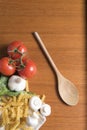 Dried fusilli pasta with tomatoes, basil and garlic Royalty Free Stock Photo