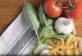 Dried fusilli pasta with tomatoes, basil and garlic Royalty Free Stock Photo