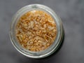 Dried garlic granules in a glass jar Royalty Free Stock Photo