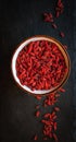 Dried goji berries in a bowl on dark background, top view Royalty Free Stock Photo