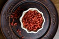 Dried goji berries in a clay bowl