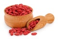 Dried goji berries in wooden bowl and scoop isolated on white background Royalty Free Stock Photo