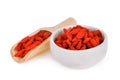 Dried goji berries in wooden scoop and white bowl Royalty Free Stock Photo