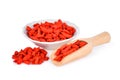 Dried goji berries in wooden scoop and white bowl isolated Royalty Free Stock Photo