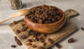 dried grapes in wooden plate on the table