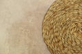 Dried Grass Straw Circular Woven Matt on Vintage Worn Background