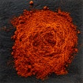 dried groundpaprika on a stand made of black stone Royalty Free Stock Photo