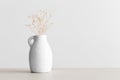 Dried gypsophila in a vase on a beige table. Flat lay with blank copy space