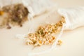 dried herbs at cotton white bags from above. Sachets filled with medicinal chamomilla and bunches Royalty Free Stock Photo